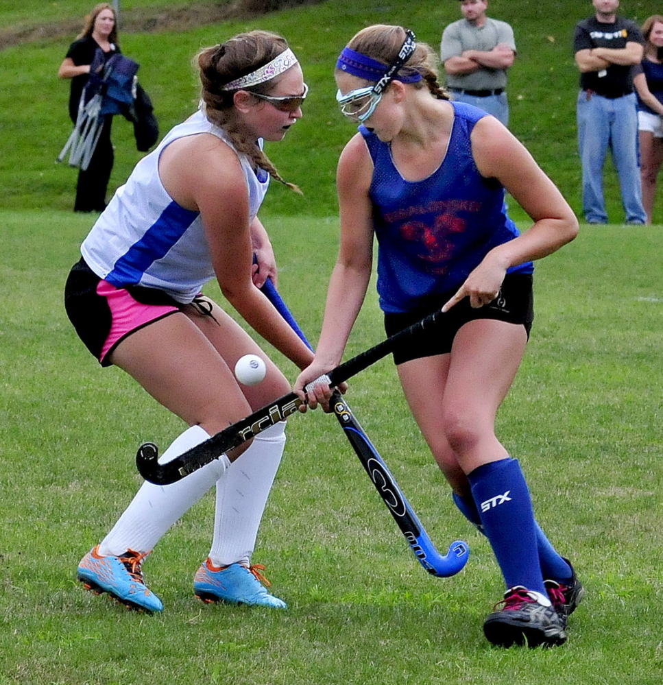 Staff photo by David Leaming 
 Lawrence's Lauren Lambert, left, and Messalonskee's Emily Hogan battle for possession during a preseason game Tuesday in Fairfield.