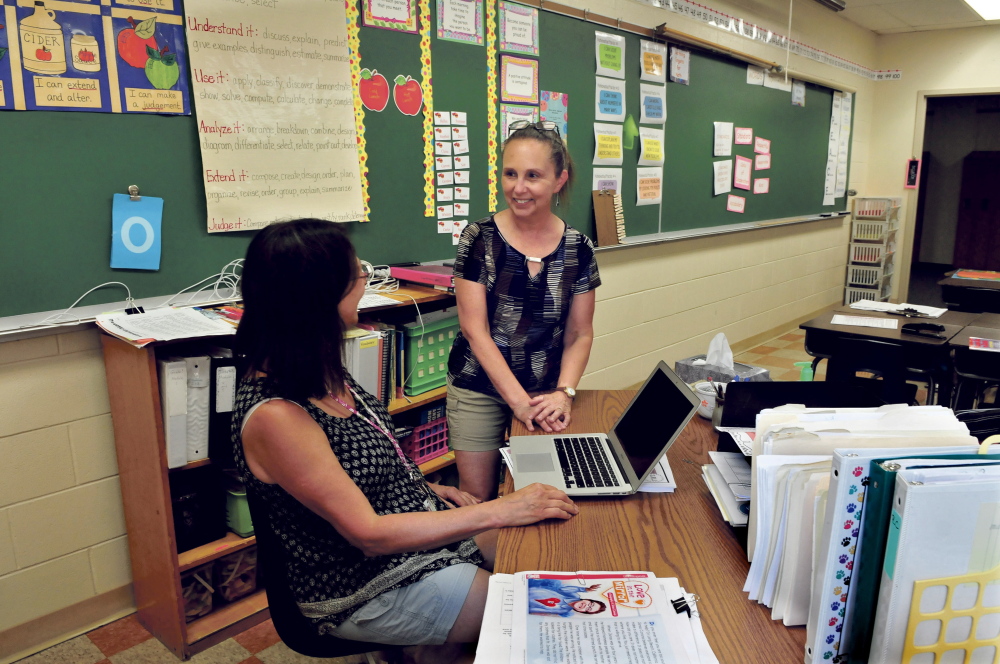 Academy Hill School teacher Brenda LaVerdiere, right, speaks with teacher Leslie Kaiser at the Wilton school on Wednesday. LaVerdiere is one of three finalists state Teacher of the Year.