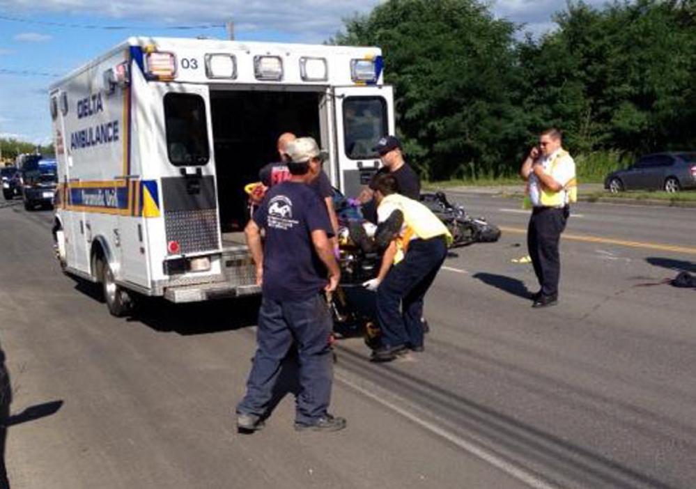 James Bolduc, of Fairfield, is loaded into an ambulance on College Avenue in Waterville Thursday afternoon. Bolduc is in critical condition at Maine Medical Center in Portland after crashing his Harley-Davidson in a chain-reaction accident.