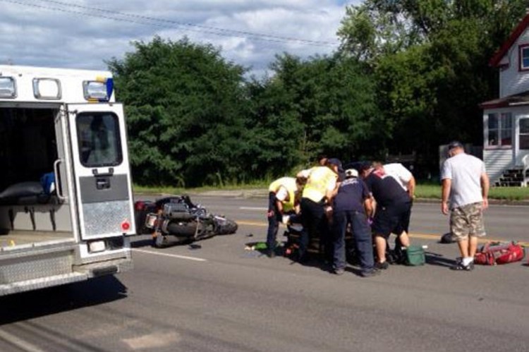 James Bolduc, of Fairfield, is treated at the scene on College Avenue in Waterville Thursday afternoon. Bolduc is in critical condition at Maine Medical Center in Portland after crashing his Harley-Davidson in the chain-reaction accident.