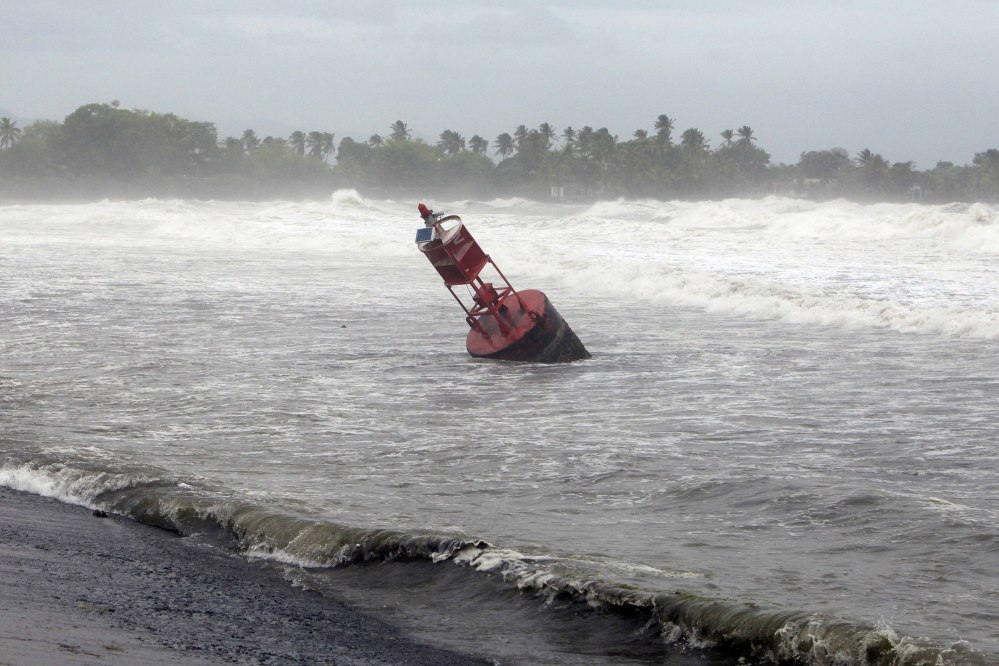 A large navigation buoy hit by strong winds and waves, floats near the coast, as Tropical Storm Erika moves away from the area in Guayama, Puerto Rico, Friday, Aug. 28, 2015. The storm was expected to dump up to 8 inches of rain across the drought-stricken northern Caribbean as it carved a path toward the U.S. (AP Photo/Ricardo Arduengo)