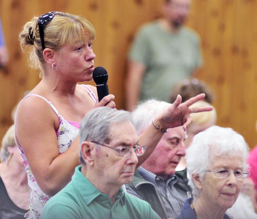 Melanie Jewell asks a question about using renewable energy in the proposed new Town Office on Saturday during the a special town meeting in the Belgrade Community Center for All Seasons.