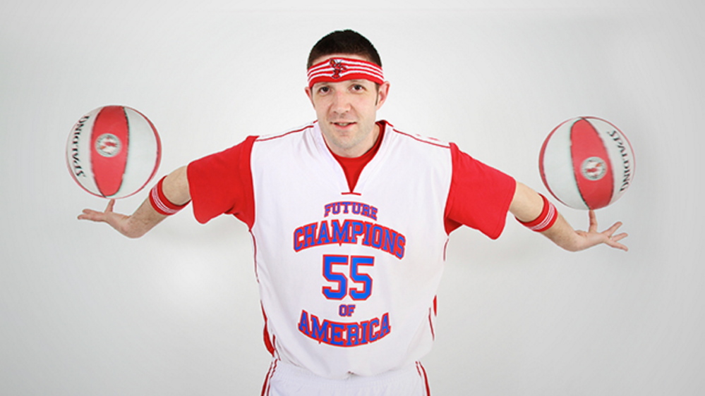 Jason Gibbons spins two balls with his hands upside down. Gibbons played with the Harlem Rockets for 10 years and also with the Harlen Globetrotters Legends team.