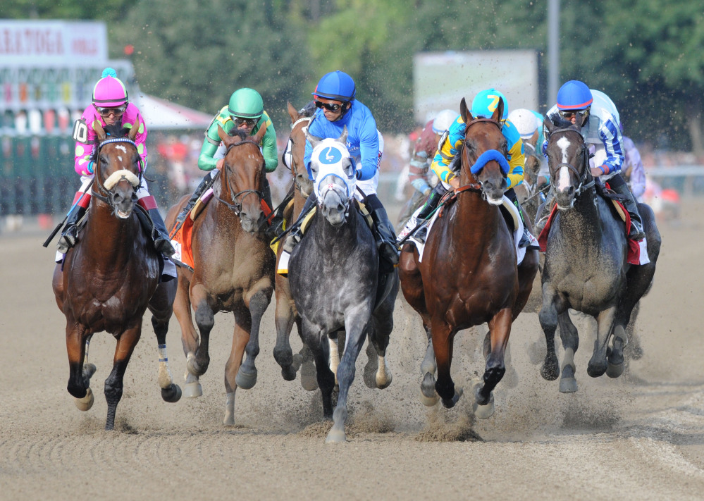 The Associated Press/ Will Waldron/The Albany Times Union
American Pharoah with Victor Espinoza, second from right, leads the field into the first turn during the Travers Stakes horse race at Saratoga Race Course in Saratoga Springs, N.Y., Saturday.