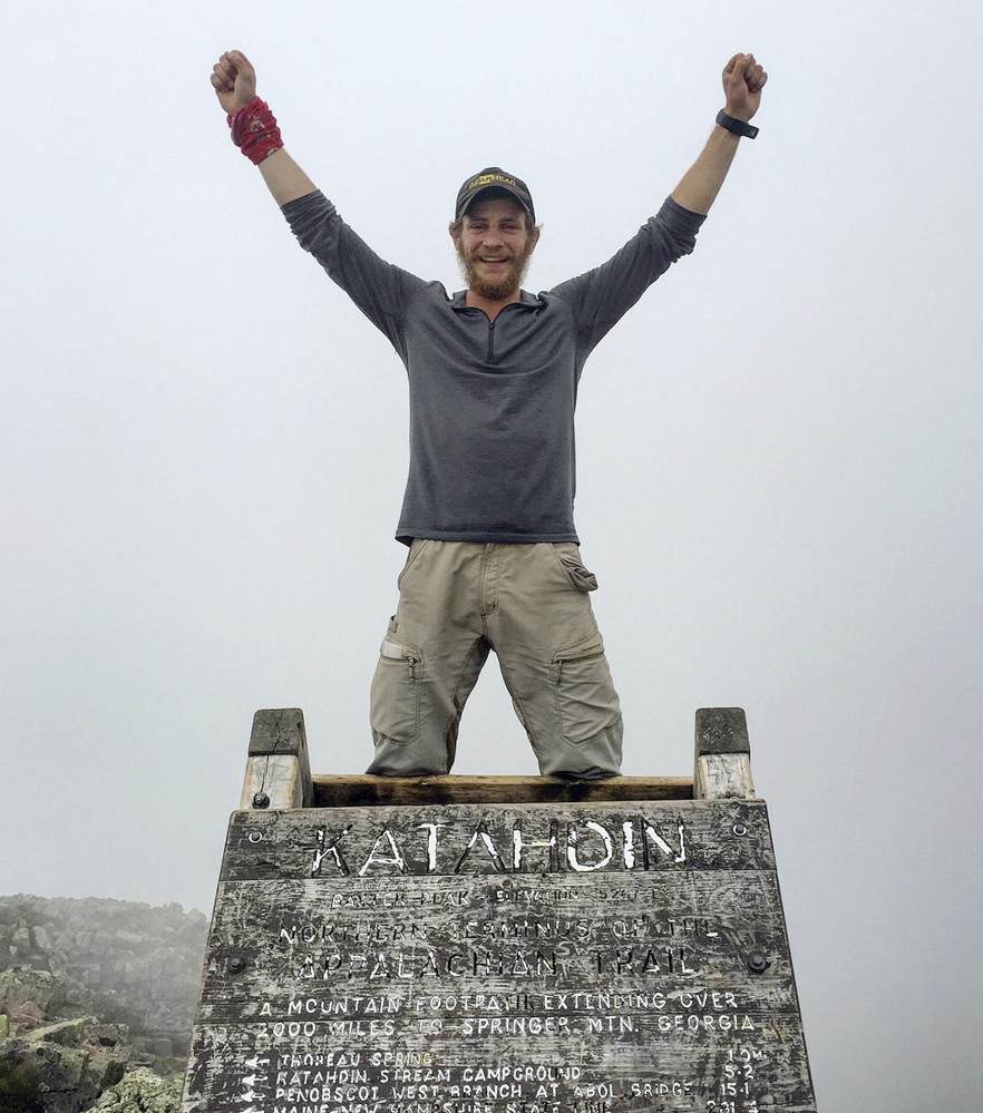 In this Aug. 5 photo provided by Jackson Spencer, Spencer poses atop Mount Katahdin along the Appalachian Trail near Millinocket. Spencer, who finished the entire trail in just 99 days, said he was looking forward to enjoying the wilderness and getting away from it all. Instead he often found the trail filled with trash, graffiti and people who seemed more interested in partying all night.