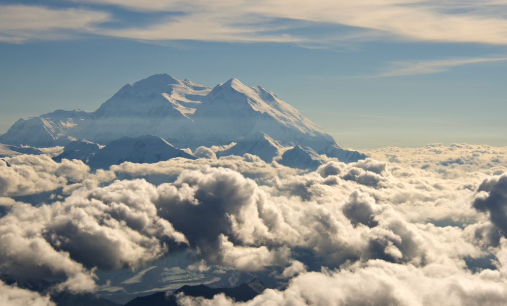 In this Monday, Aug. 3, 2015, aerial photo provided by Holland America Line, Mount McKinley pierces through the clouds above Denali National Park and Preserve in Alaska.