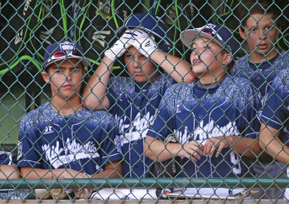 Players in the Lewisberry, Pennsylvania dugout watch in the sixth inning against Japan in the Little League World Series championship Sunday in South Williamsport, Pa. Japan won 18-11.