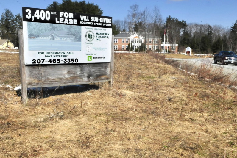 A sign advertising retail space at FirstPark in Oakland last year in a field beside current tenants Kennebec Veterinary Services, left, and PFBF company. The town of Rome is asking the Kennebec Regional Development Authority and First Park to specify long-term costs and benefits of the arrangement they have with the park and outline ways towns and cities can leave the authority.