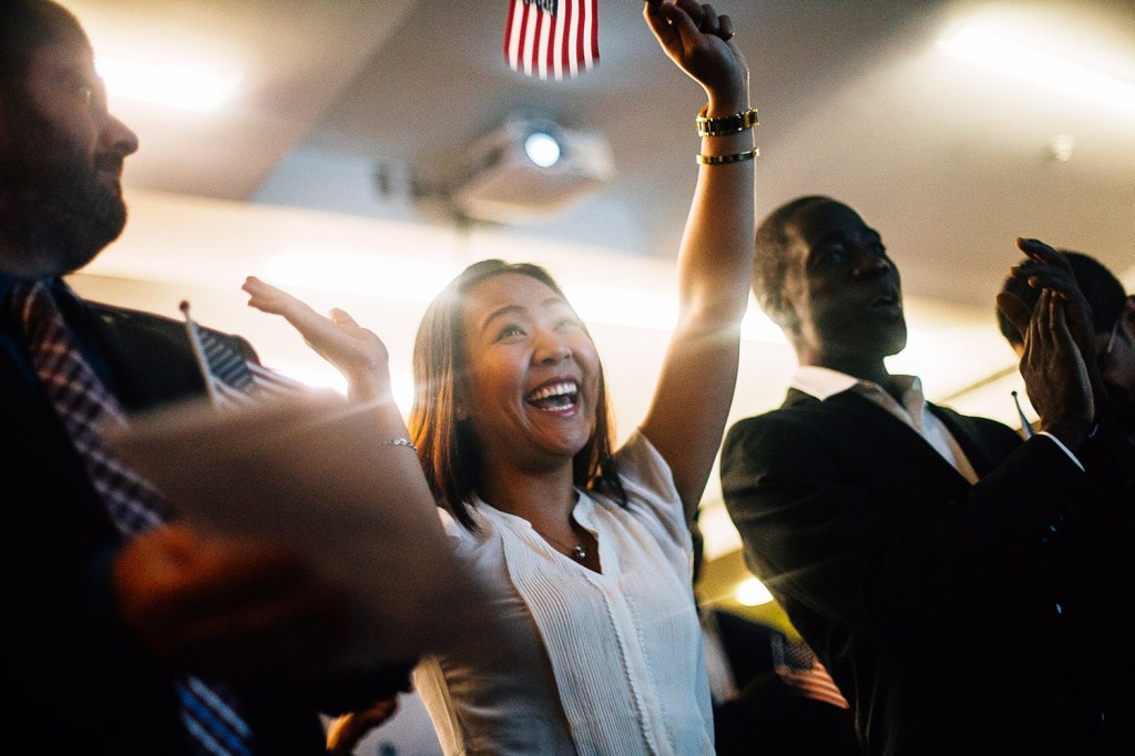 Giang Duong laughs in celebration after she is officially declared a citizen of the United States during the naturalization ceremony at the Portland Public Library in this 2015 file photo.