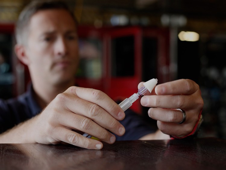 In this August 2015 photo, Dan Svenson, a Portland firefighter and paramedic, demonstrates the procedure for administering Narcan nasally, in between calls at Central Station on Congress Street. 