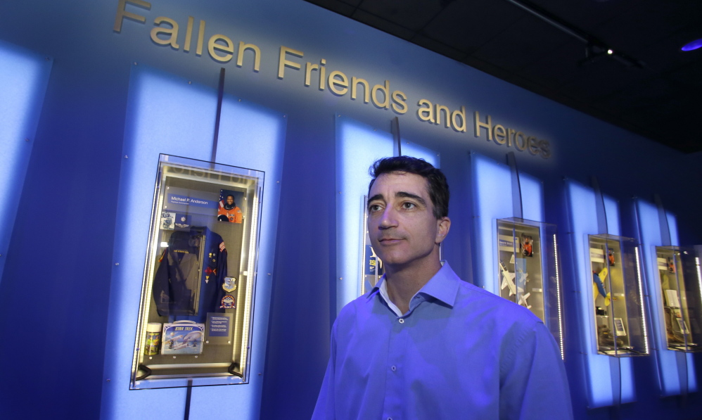 Michael Ciannilli, who oversaw the “Forever Remembered” exhibit and memorial to the astronauts who died on the Columbia and Challenger space shuttles, stands in the display at the Kennedy Space Center Visitor Complex in Cape Canaveral, Fla.