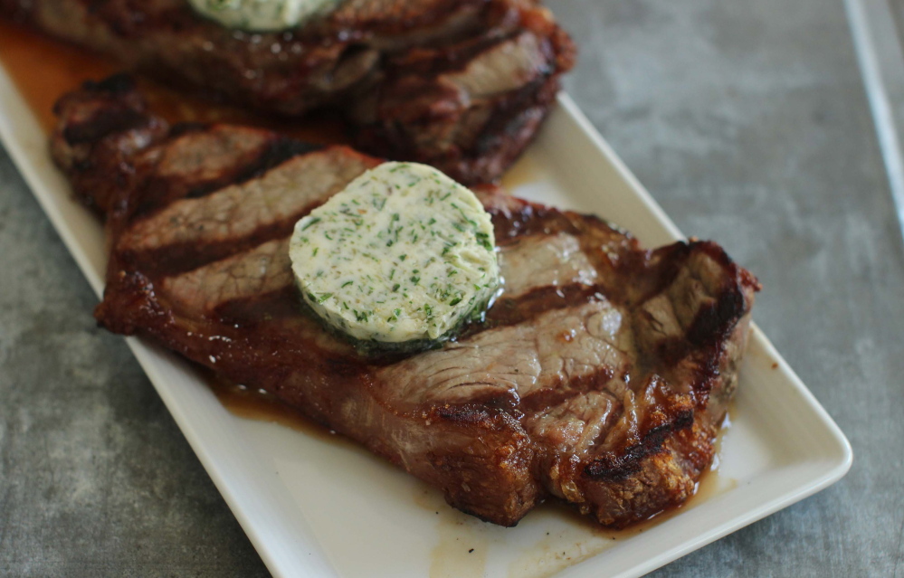 Topping a home-grilled steak with a compound butter adds richness to the taste.