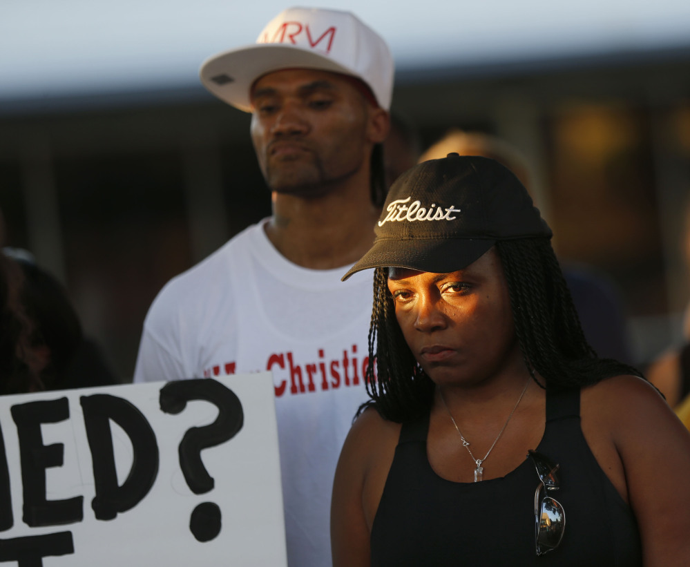 Denise Hamilton of Plano, Texas, attends a vigil for Christian Taylor on Monday in Arlington, Texas. Taylor was killed by police at a car dealership on Friday.