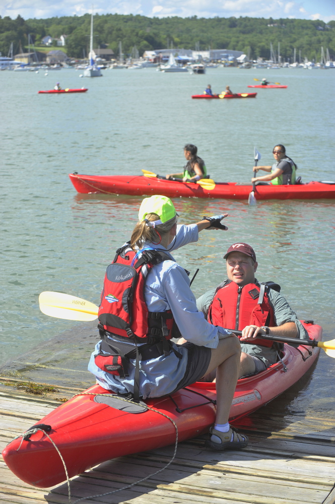 L.L. Bean paddling guide Lee Bumsted assists a kayaking course participant. Certain types of kayaks should be used in different waters, such as rivers versus the open ocean, and boaters should be trained to handle distress situations.