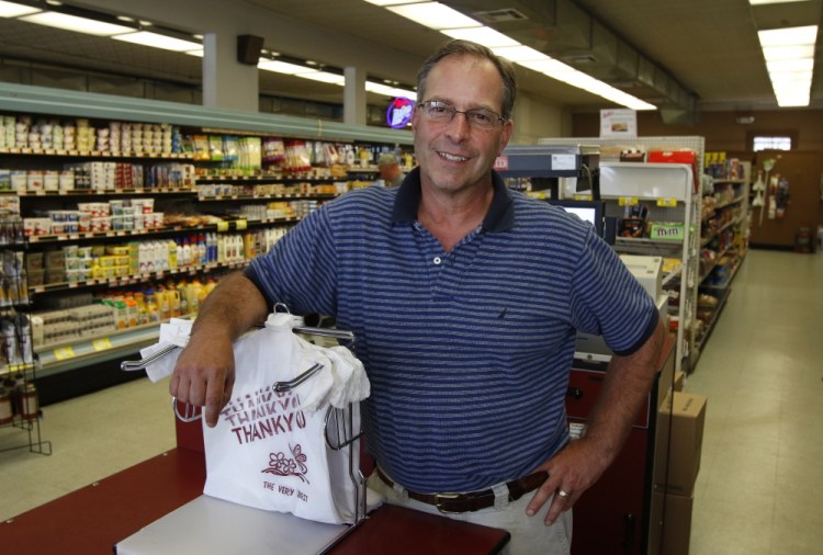 South Portland grocer Alan Cardinal acknowledges it’s not ideal to suddenly charge customers for use of bags, but says the environmental concerns are legitimate.
Joel Page/Staff Photographer