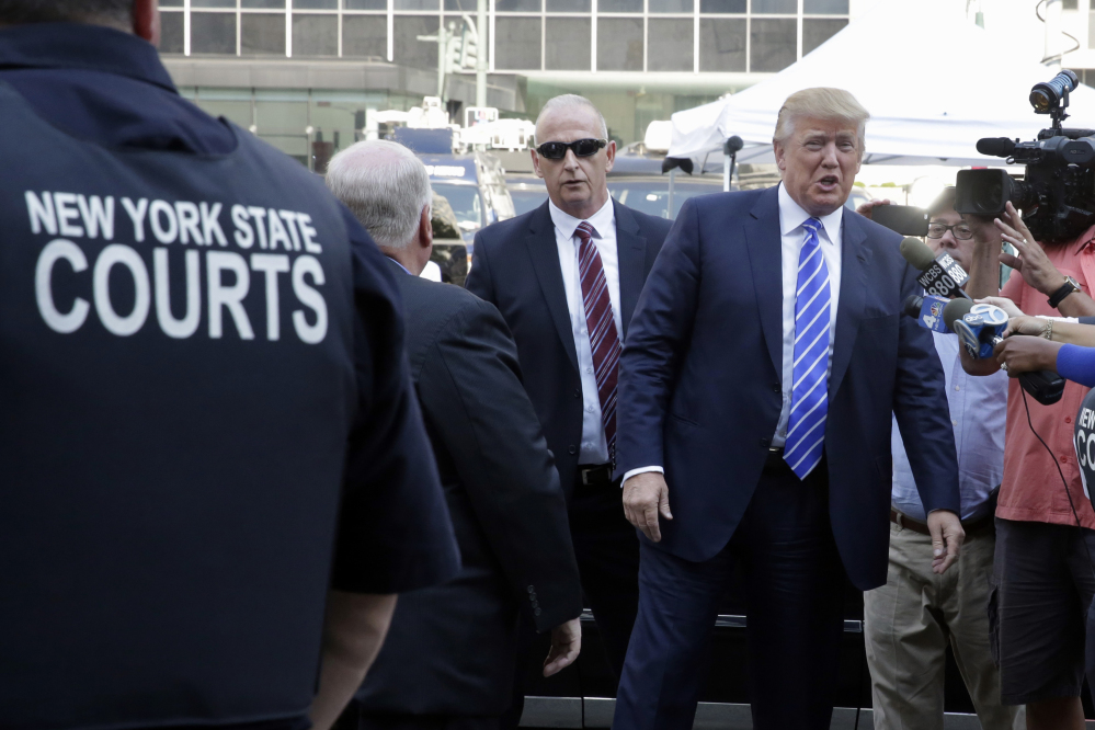 Republican presidential candidate Donald Trump arrives at New York state Supreme Court for jury duty on Monday. Trump is taking a break from courting voters to go to court as a potential juror. He shook hands and fist-bumped bystanders as he reported in Manhattan.