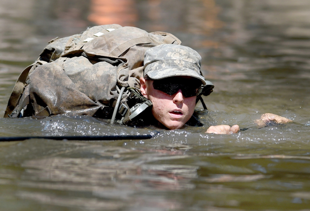 A female Army Ranger candidate crosses the Yellow River on a rope bridge on Aug. 4 at Camp James E. Rudder on Eglin Air Force Base, Fla. Two out of 19 females who started Ranger School this year have completed the course.