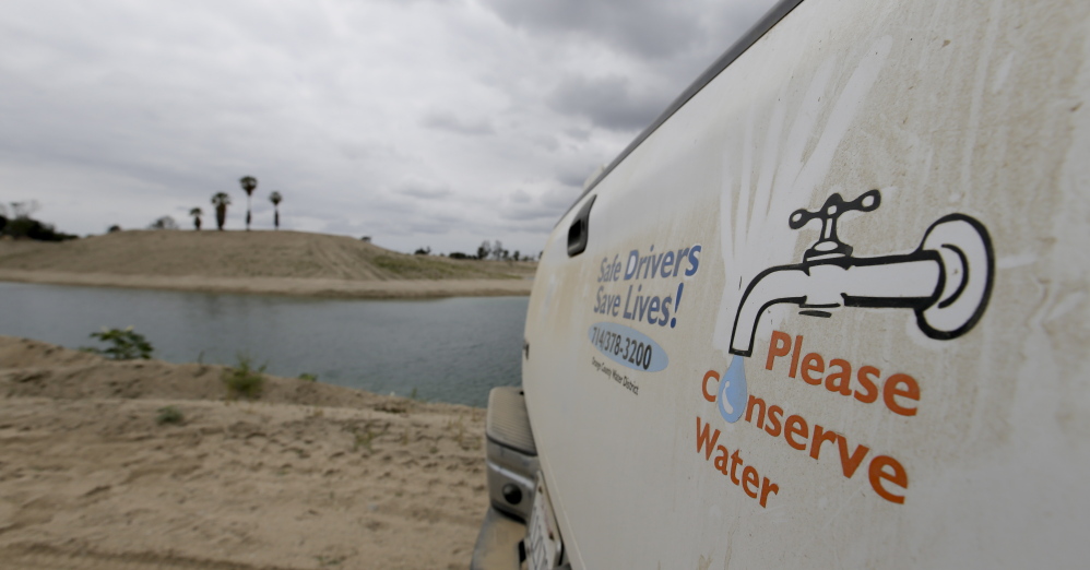 A decal on the dusty tailgate of an Orange County Water District truck promotes water conservation.