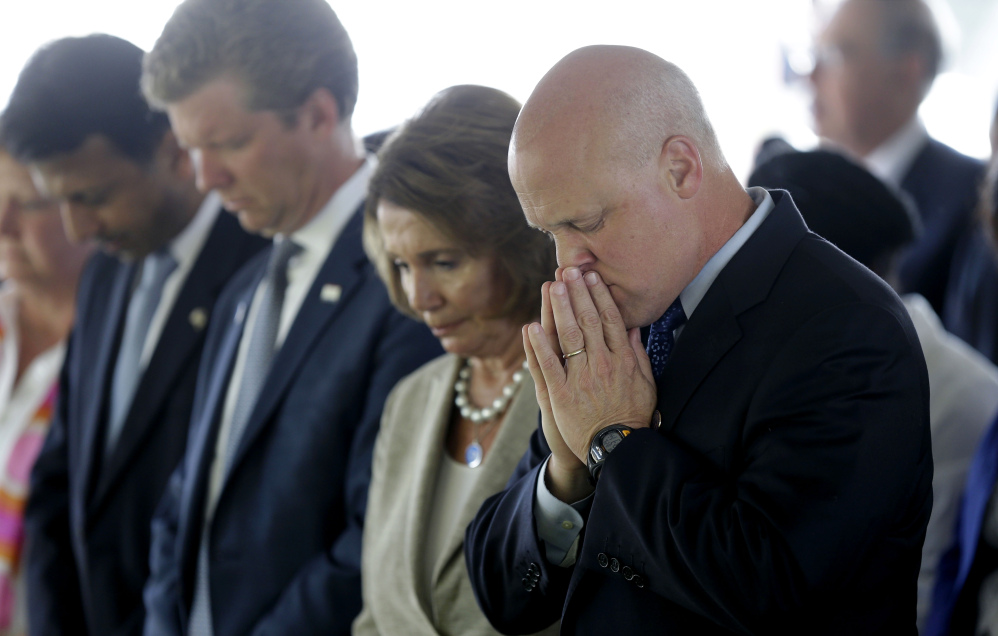 From right, New Orleans Mayor Mitch Landrieu, House Minority Leader Nancy Pelosi, Director of Office of Management and Budget Shaun Donovan and Louisiana Governor Bobby Jindal, bow in prayer during the invocation at a wreath laying ceremony at the Hurricane Katrina Memorial, on the 10th anniversary of Hurricane Katrina in New Orleans, on Saturday.