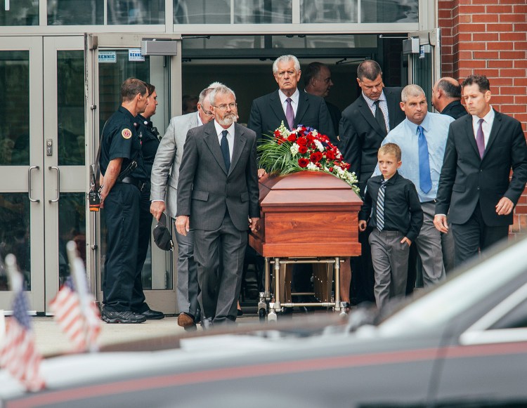 Family and friends escort her casket after services for Wendy Boudreau at Thornton Academy in Saco on Tuesday.