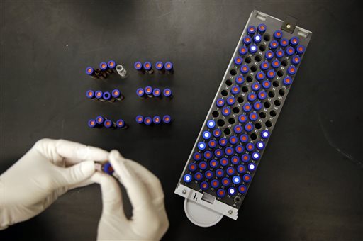 Christine Jelinek, a postdoctoral fellow at Johns Hopkins University in Baltimore, works with a tray of vials containing cerebral spinal fluid. The Associated Press