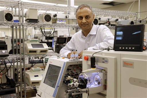 Dr. Akhilesh Pandey, a researcher at Johns Hopkins University, stands alongside a mass spectrometer in his laboratory. Pandey's research analyzes both adult and fetal tissue, and by identifying which proteins are present, he can get clues that could be used to help detect cancer in adults earlier. The Associated Press