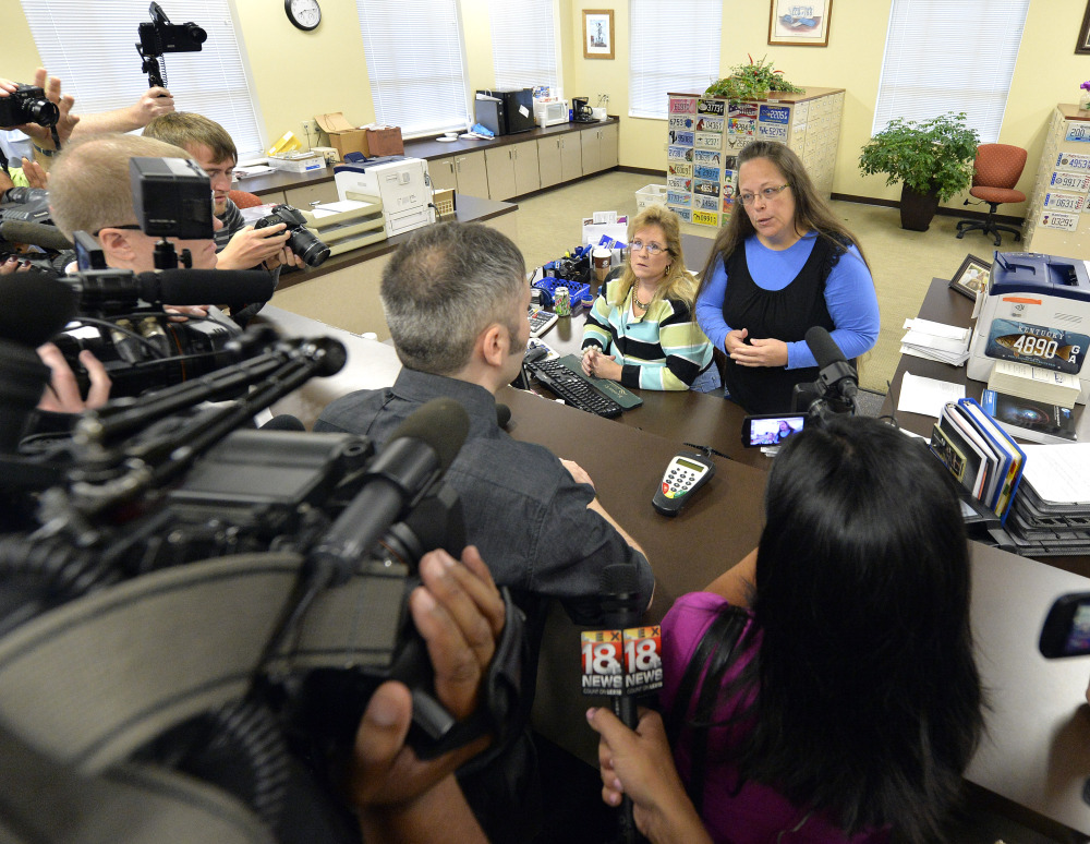 Rowan County Clerk Kim Davis, right, talks with David Moore following her office’s refusal to issue marriage licenses at the Rowan County Courthouse in Morehead, Ky., Tuesday.