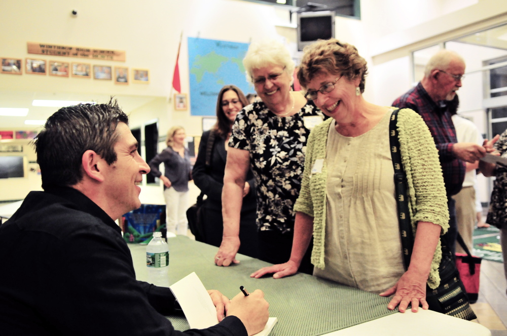 Blanco signs books following his talk for Bailey Public Library trustees Elizabeth Sienko, Mary Jane Auns and Winthrop Town Council Chairwoman Sarah Fuller.