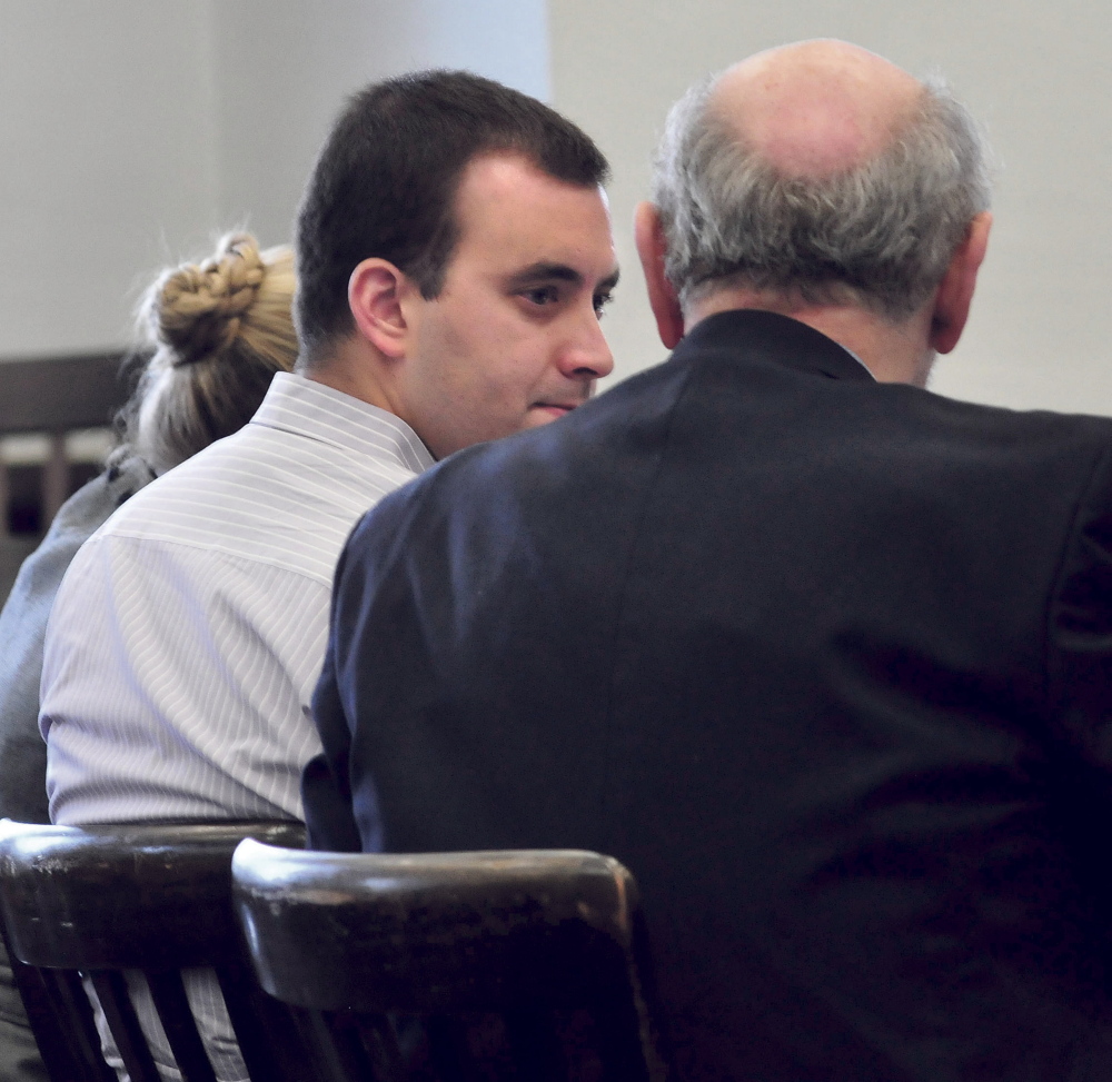 Defendant Andrew Maderios speaks with attorney Leonard Sharon during his jury trial on domestic violence charges at Somerset County Superior Court in Skowhegan on Monday.