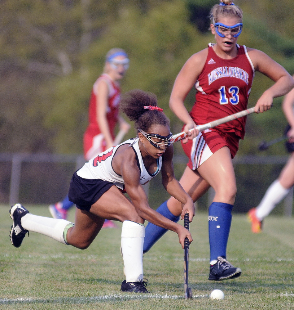 Staff photo by Andy Molloy 
 Cony High School's Kami Lambert, left, moves past Messalonskee's Lydia Dexter during a Kennebec Valley Athletic Conference Class A game Wednesday in Augusta.