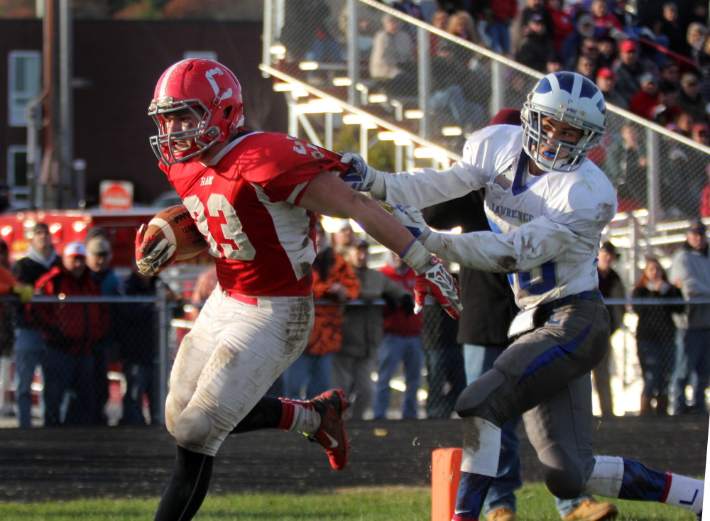 Photo by Jeff Pouland 
 Cony High School running back Reid Shostak fights off Lawrence's Dustin Simpson-Bragg to score a second half touchdown during a Pine Tree Conference Class B seminfinal game last season.