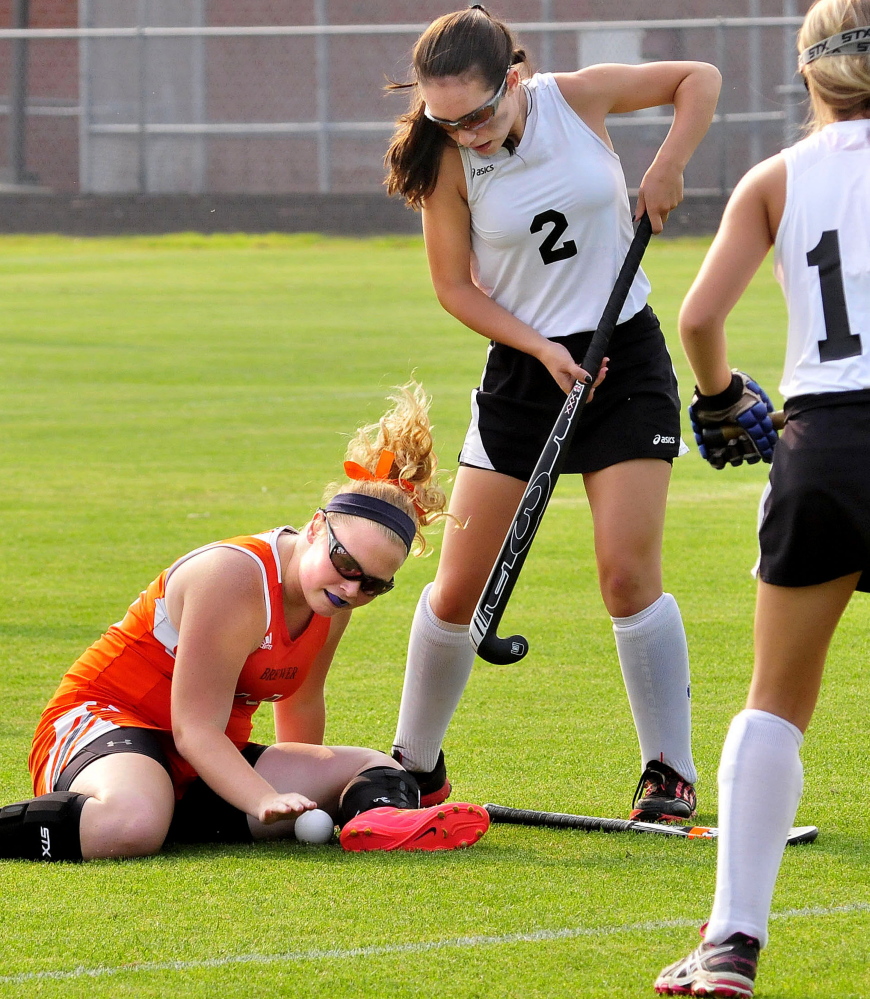 Skowhegan’s Maliea Kelso (2) stands over Brewer’s MJ Sellars during a Class A North season-opening game Wednesday in Skowhegan.