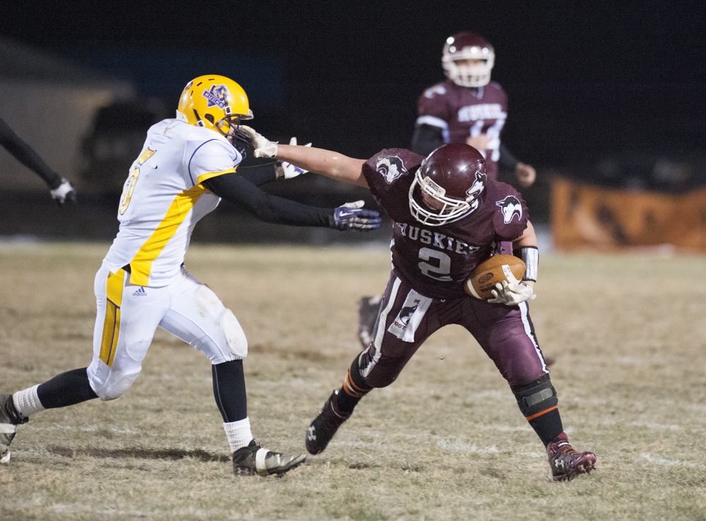 Kevin Bennett photo 
 Maine Central Institute running back Alex Bertrand shakes off a tackle by Bucksport’s Chase Carmichael during the Little Ten Conference title game last season.