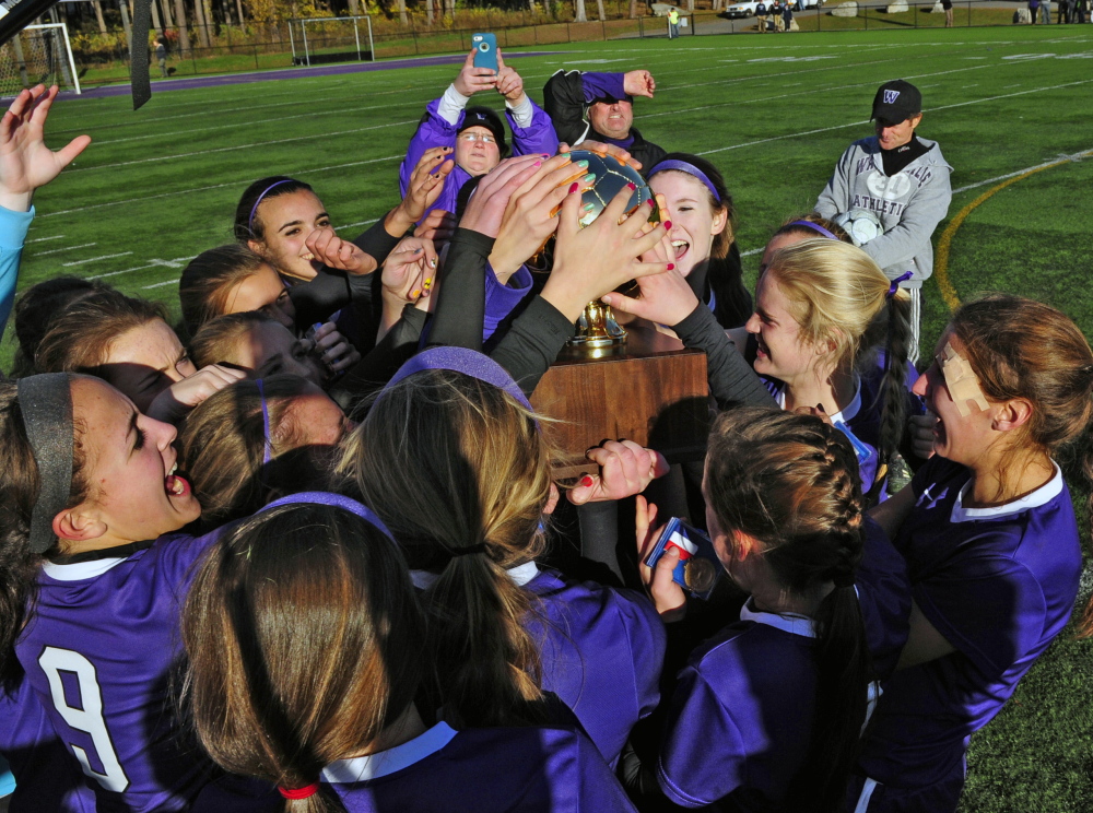 Staff file photo by Joe Phelan 
 The Waterville girls soccer team celebrates after it edged Cape Elizabeth 1-0 to win the Class B state championship last season. The Purple Panthers have a new coach but same expectations this season.
