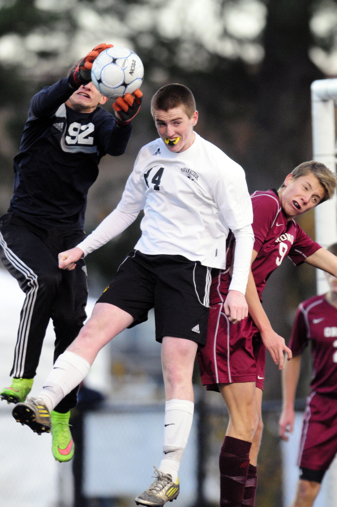 Staff file photo by Joe Phelan 
 Orono keeper Alik Espling, left, makes a save in front of Maranacook's Jason Brooks, center, while Orono's Mazime Neitschke defends during the Class C state championship game last fall.