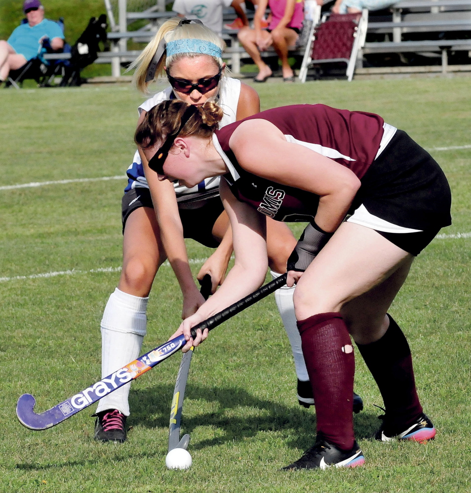 Staff photo by David Leaming 
 Nokomis' Jessica Cloutier, front, and Lawrence's Hallee Parlin go after a loose ball during a Kennebec Valley Athletic Conference Class B game Thursday in Fairfield. The Bulldogs won 4-1.