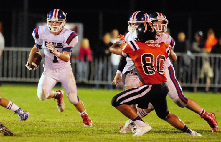 Staff photo by Joe Phelan 
 Messalonskee halfback Colby Dexter looks for room to run during a Pine Tree Conference Class B game Friday night against Gardiner at Hoch Field.