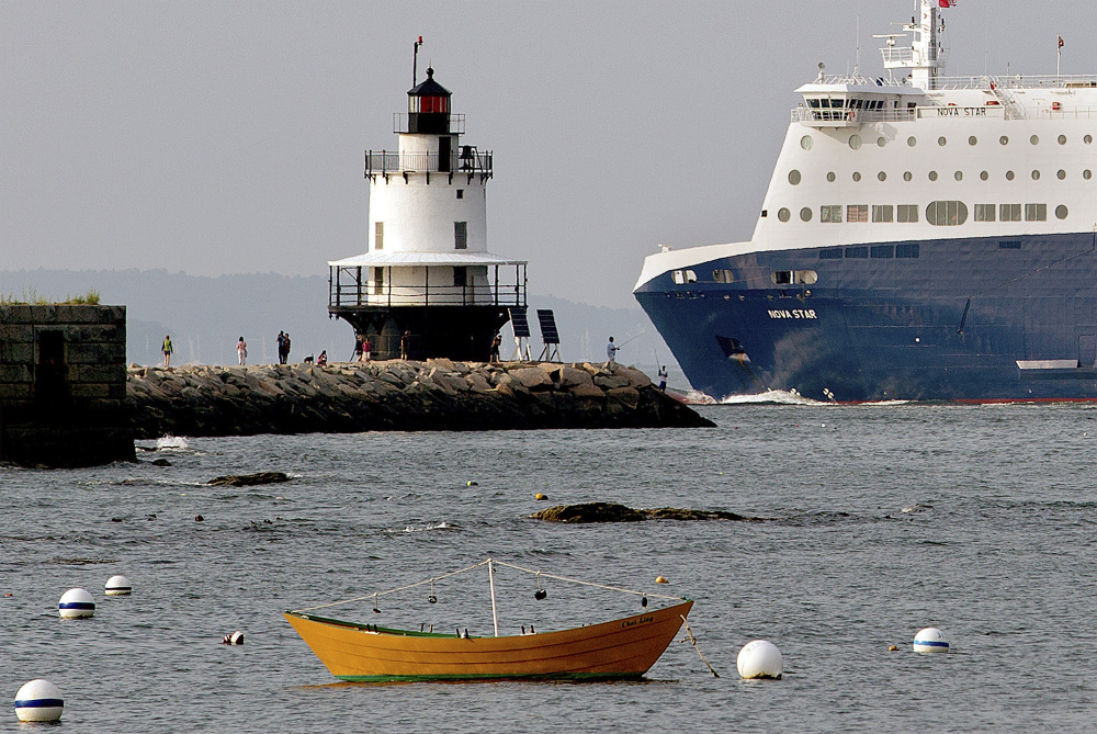 Gabe Souza/Portland Press Herald
The Nova Star ferry travels past fishermen and tourists near the Spring Point Ledge Light on its way to the Ocean Gateway terminal in Portland. With the decline of groundfishing and freight shipping, Portland increasingly relies on tourists passing through its port.