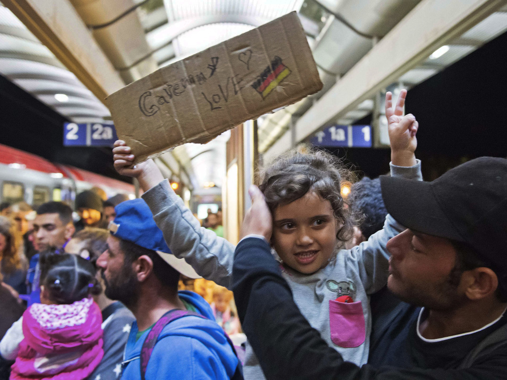 Refugees arrive at the train station in Saalfeld, central Germany, Saturday.