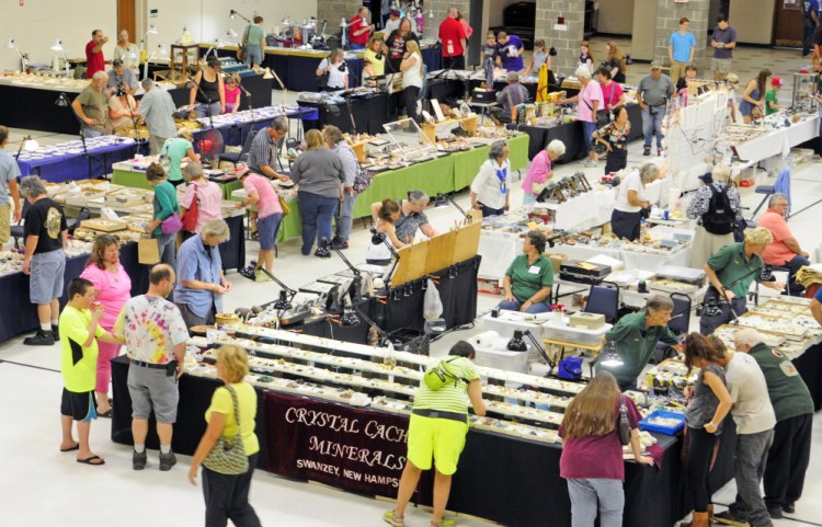 Staff photo by Joe Phelan
People look over the displays Saturday during the Rockhounders 26th Annual Gem and Mineral Show at the Augusta State Armory.
