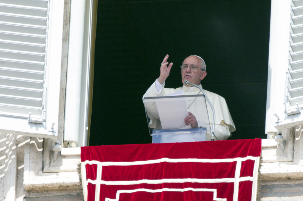 Pope Francis delivers his blessing to faithful during the Angelus noon prayer from his studio window overlooking St. Peter’s Square at the Vatican, Sunday.