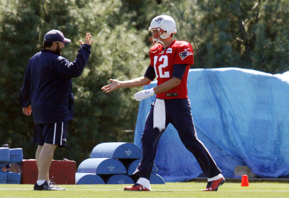 New England Patriots quarterback Tom Brady, right, greets Patriots defensive coordinator Matt Patricia at the start of practice Saturday in Foxborough, Mass. Brady will start against the Pittsburgh Steelers on Thursday night’s season opener after a federal judge overturned Brady’s four-game suspension last Thursday.