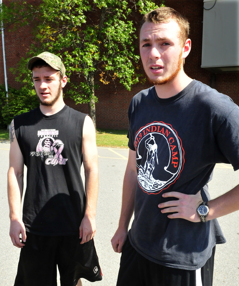 Former Skowhegan Area High School football players Josh Meng, left, and Dan Quirion speak about their friend and classmate Scott Brown after a memorial gathering Monday at the school. Brown died Sunday evening while swimming in Embden Pond.