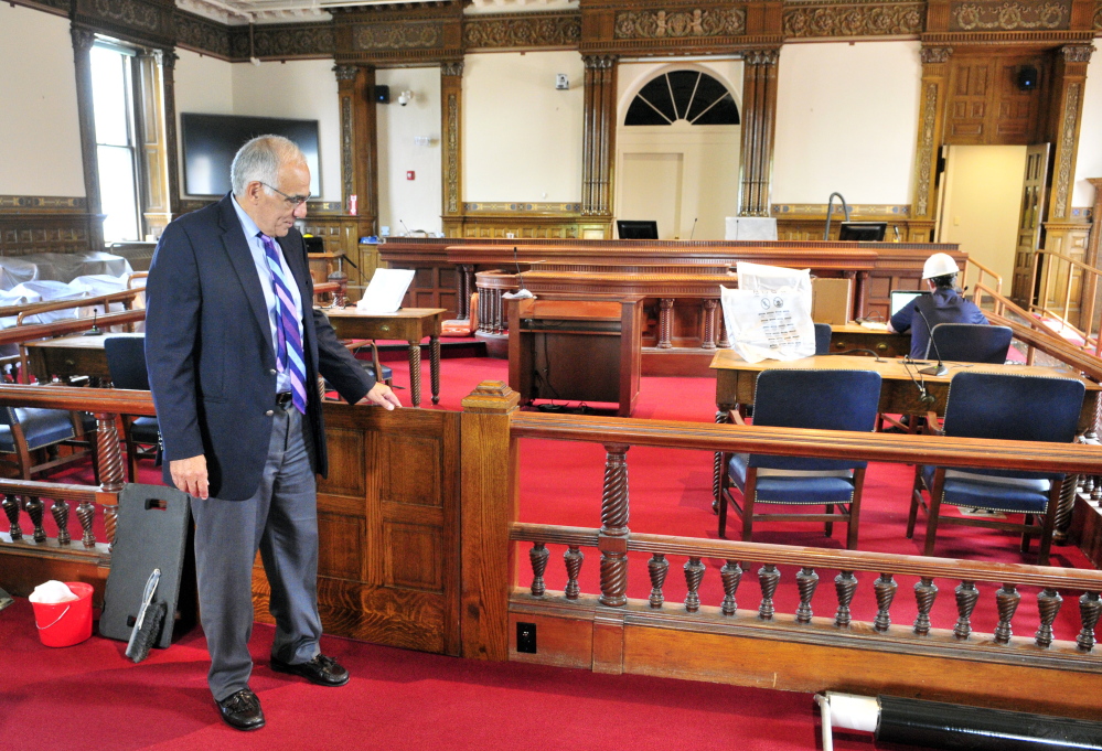 Supreme Court Justice Joseph Jabar points out a new gate Thursday during a tour of the recently renovated old courtroom in the Kennebec County Courthouse in Augusta.