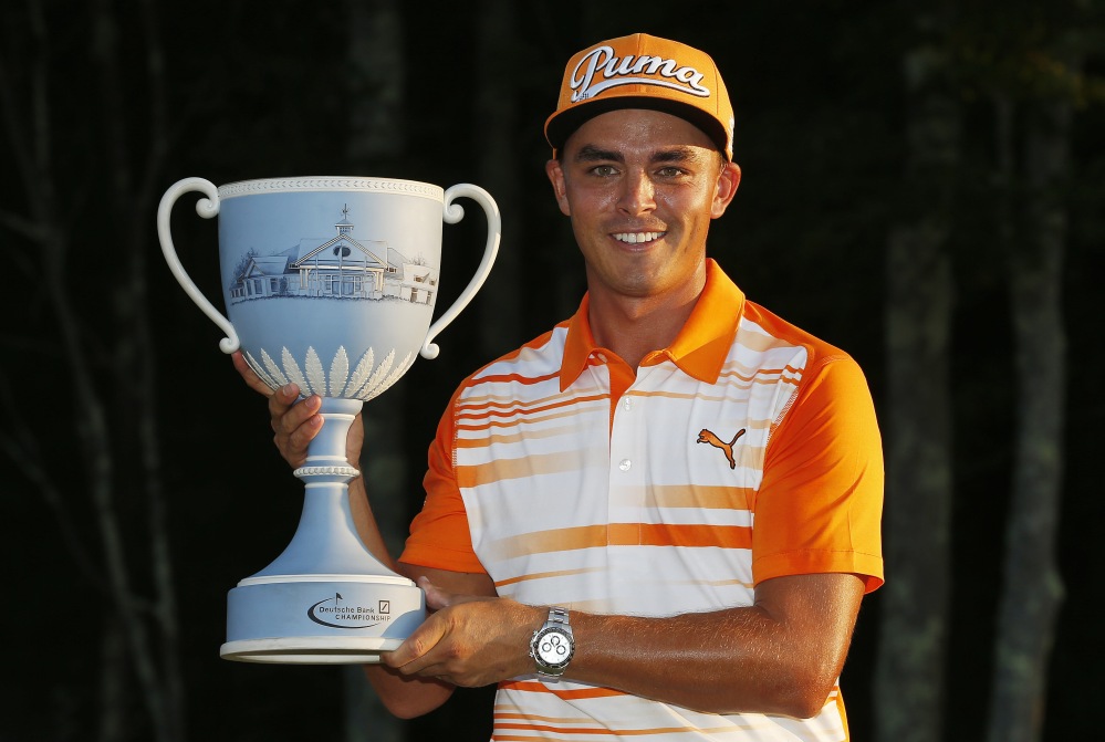 Rickie Fowler holds the trophy after winning the Deutsche Bank Championship Monday in Norton, Mass.