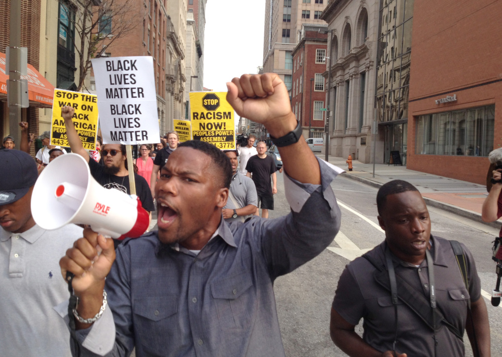 In this file photo, Pastor Westley West, from Faith Empowered Ministries, leads protesters as they march towards Pratt Street and the Inner Harbor, Wednesday, Sept. 2, 2015, in Baltimore, as the first court hearing was set to begin in the case of six police officers criminally charged in the death of Freddie Gray.