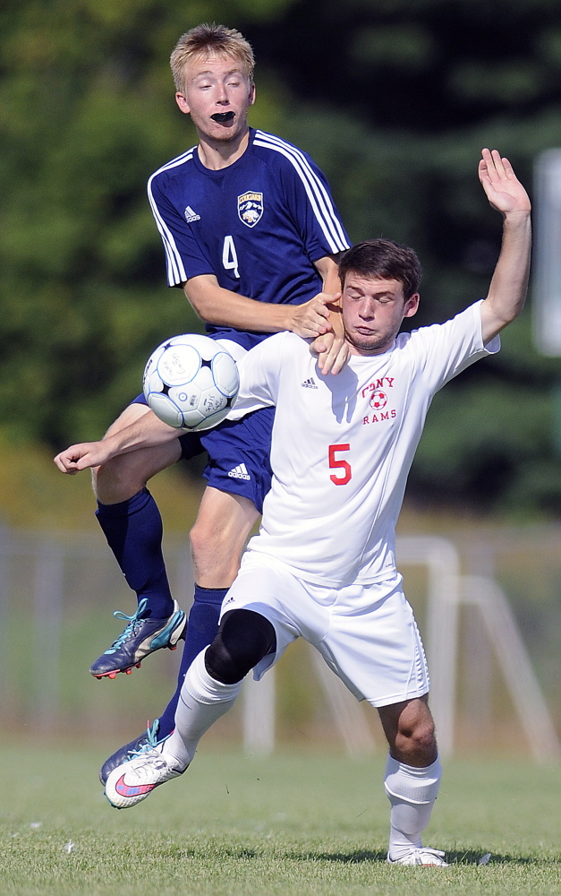 Staff photo by Andy Molloy 
 Cony High School's Tyler Sproul, right, attempts to block Mt. Blue's Thomas Wing during a Kennebec Valley Athletic Conference Class A game Tuesday in Augusta.