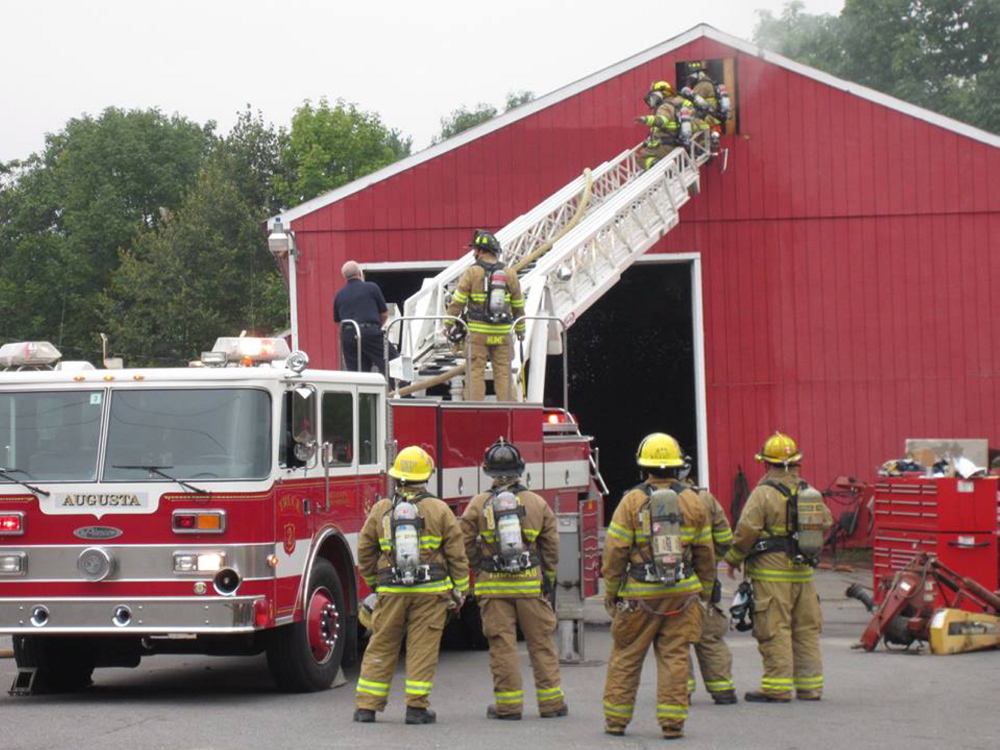 Augusta firefighters tackle a “stubborn” fire that started Wednesday morning in the attic of Kramer’s Inc. tractor dealership on West River Road in Sidney.