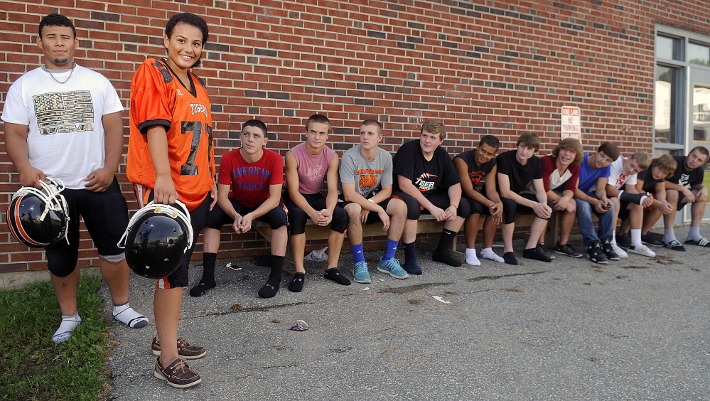 Members of the Gardiner football team have all eyes on Alex Thang and his sister, Kassidy, on Wednesday at the high school.