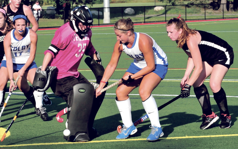 Staff photo by David Leaming 
 Thomas goalie Abbie Charrier blocks a shot from Colby's Misha Strage during a non-conference game Wednesday night at Thomas College. Colby prevailed 4-2.